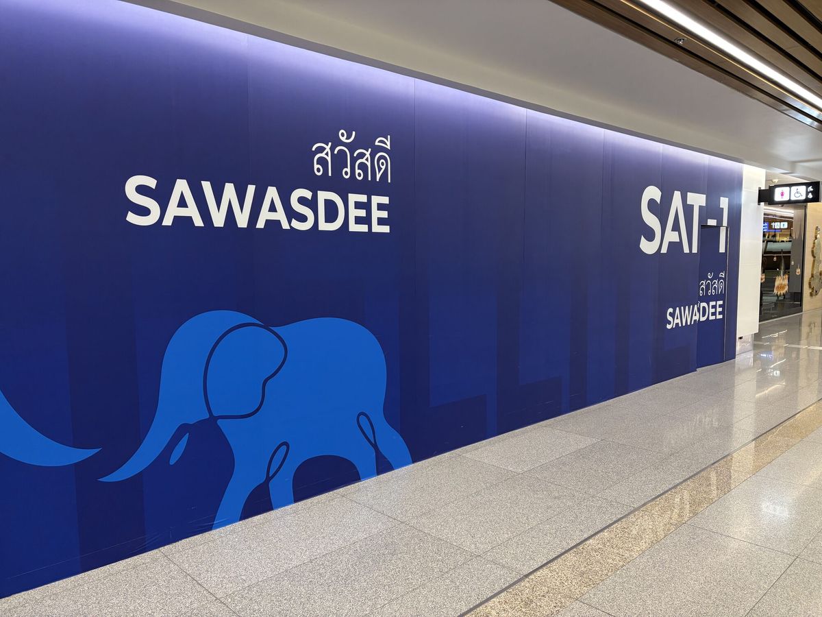 スワンナプーム空港の通路。紺色の壁に象のシルエットと「SAWASDEE」「SAT-1」の文字